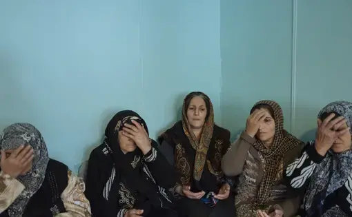 Women pray after the death of Polat Kerim (a former lawyer of the region), 80, in Sivu village. After the death of their loved ones, Talysh women and men mourn in the deceased's house but in separate rooms, for three days. Image by Emin Ozmen / Magnum Photos. Azerbaijan, 2018.