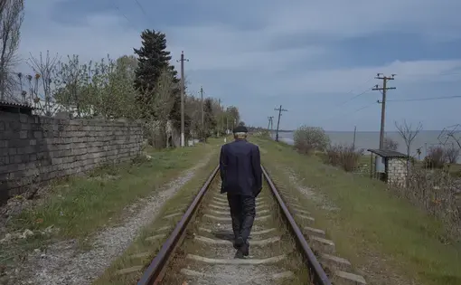 A man walks on railway tracks. Image by Emin Ozmen/Magnum Photos. Azerbaijan, 2018. A man walks on railway tracks. Image by Emin Ozmen/Magnum Photos. Azerbaijan, 2018.