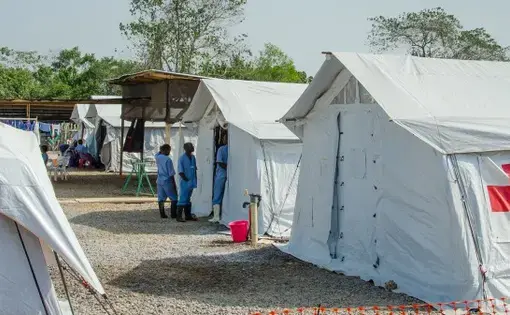 An Ebola treatment center run by the Red Cross and Red Crescent Societies in Sierra Leone. It contained zero patients in February. Hundreds of millions in donations went to the construction and operation of NGO-run centers in the three hard-hit countries. Image by Amy Maxmen. Sierra Leone, 2015.