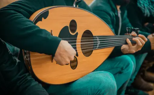 A musician plays an oud, a traditional Middle Eastern instrument. Image by Nayef Hammouri / Shutterstock. Palestinian Territories, undated.
