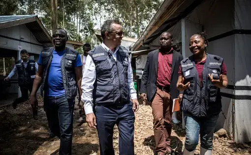 WHO director-general Tedros Adhanom Ghebreyesus (in white shirt) in Katwa. Image by John Wessels. Democratic Republic of Congo, 2019. WHO director-general Tedros Adhanom Ghebreyesus (in white shirt) in Katwa. Image by John Wessels. Democratic Republic of Congo, 2019.