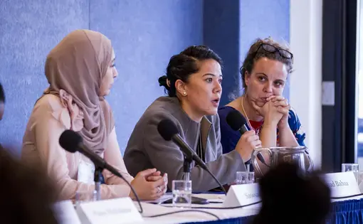 Suhad Babaa, executive director of Just Vision, speaks at a panel on community-level peace building at the "Beyond War" conference. Image by Jin Ding. Washington, D.C., 2018.
