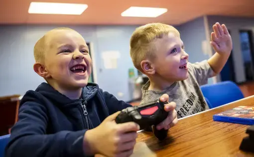 Kyle Hamilton, 7, left, and Lucas Barpon, 7, both of Possilpark, play a wrestling video game on a Playstation during a Young People's Futures session, Oct. 25, 2019, at Possilpoint Community Centre in Possilpark, Glasgow, Scotland. Image by Michael Santiago. United Kingdom, 2019.
