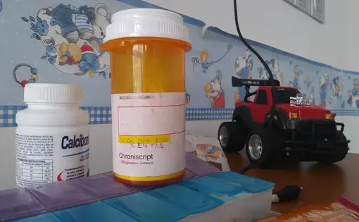 Eliécer Aguiar's medicine and toys on a table, at his hospitalization room in the Hospital J.M de los Ríos, in Caracas. Twelve-year-old Eliécer suffers from chronic kidney diesease and needs a kidney transplant, but with Venezuela's transplant system almost completely paralyzed and the organ waiting list still on hold, his future seems uncertain. Image by Flaviana Sandoval. Venezuela, 2018.&nbsp;