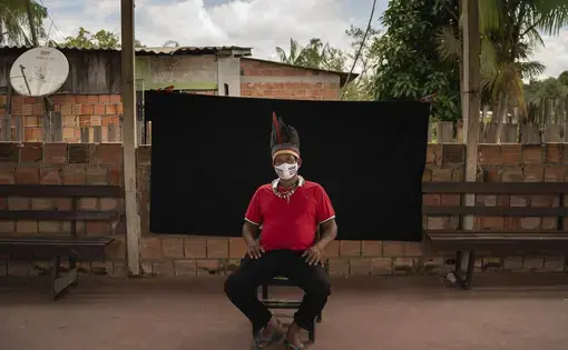 Indigenous leader Jose Augusto, 48, of the Miranha indigenous ethnic group, poses for a portrait wearing a face mask amid the spread of the new coronavirus, at the Park of Indigenous Nations community in Manaus, Brazil, Thursday, May 28, 2020. His mask reads in Portuguese: "Indigenous lives matter." Image by Felipe Dana / AP Photo. Brazil, 2020.