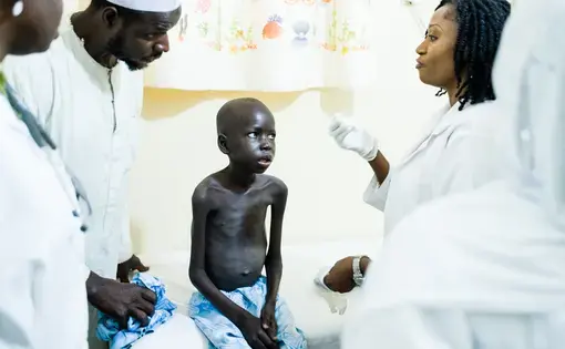 Yusuf Adamu, 12, in April arrived at Asokoro Hospital in Abuja, with a severe case of late-stage AIDS. Doctors suspected that he had tuberculosis and he’s shown here in the X-ray room. Adamu’s mother died from AIDS when he was 3, which is when he was first diagnosed. Yusuf’s father, Ibrahim, and his two other wives are infected, as is a sister. The impoverished family has difficulty paying the bus fares to travel from Yusuf’s home to the hospital for regular checkups and medication the necessary medication adjustments. Nigeria has more children infected by their mothers than any country in the world, and, in turn, the largest number of children dying from AIDS. Image by Misha Friedman. Nigeria, 2018. Media file: farfromover-1.jpg
