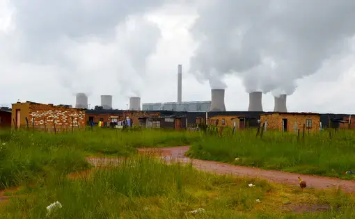 Duvha Power Station looms over the Masakhane informal settlement near eMalahleni in Mpumalanga. In 2015, the government pledged R18-billion to assist or relocate 15 mining-affected communities, including Masakhane. Image by Mark Olalde. South Africa, 2017.