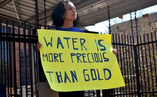 Colombian activist Ximena Gonzalez protests outside AngloGold Ashanti's headquarters in Johannesburg in 2016. Image by Mark Olalde. South Africa, 2016.