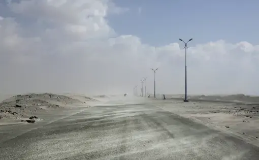 This Feb. 15, 2018, photo shows sand drifting over an empty highway from Abyan to Aden in Yemen. Violence, famine and disease have ravished the country of some 28 million, which was already the Arab world’s poorest before the conflict began. The conflict pits a U.S.-backed, Saudi-led coalition supporting the internationally recognized government, which has nominally relocated to Aden but largely lives in exile, against rebels known as Houthis. Image by Nariman El-Mofty. Yemen, 2018.
