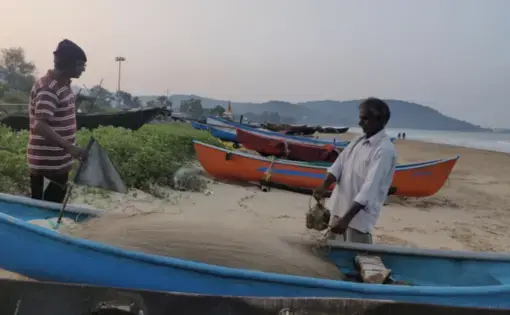 Sadanand Malshekar (right), 62, is among the thousands of fisherfolk who are worried that the Karwar port’s expansion will pollute the water in the fishing harbour and damage the beach they use to anchor their boats. Image by Disha Shetty / IndiaSpend. India, 2020.