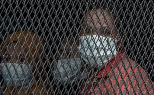 A woman looks out from an immigration truck transporting her to detention following a raid in Petaling Jaya, Kuala Lumpur on May 20. Image by Hasnoor Hussain. Malaysia, 2020.