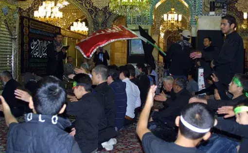 Young men attend a ceremony at the Rukaya Shrine in Damascus. Shiites and Alawites, seen here, have tended to support the Assad government. Image by Reese Erlich. Syria, 2013. Media file: rukaya-shrine-1-590.jpg