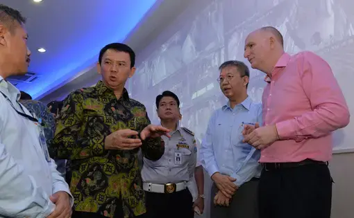 Basuki “Ahok” Tjahaja Purnama speaks with diplomats at the TransJakarta Bus headquarters in March 2016. Image by Australian Embassy Jakarta/ Timothy Tobing. Indonesia, 2016.