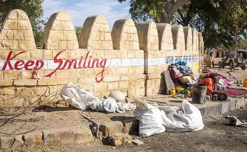 "Keep Smiling" is emblazoned on a wall in Jaisalmer. Image by Micha Weber / Shutterstock.com. India, 2016.