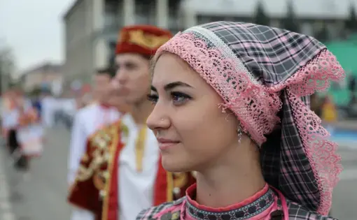 On Oilman's Day in Tatarstan,Russia, a women stands in the national clothing. September, 2018. Tatarstan, Russia. Image by Denis Gaponov /Shutterstock.