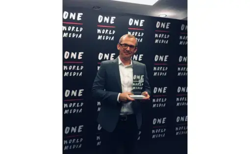 Pulitzer Center grantee Marc Ellison holding the 2019 OWM Digital Media Award. Image courtesy of Marc Ellison.