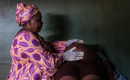 Woman examining pregnancy in Lagos. Image by Misha Friedman. Nigeria, 2018.