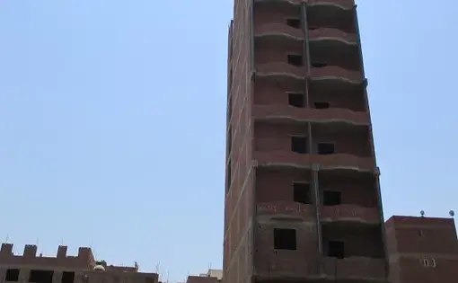 A newly-built apartment block in Kafr. Each floor of a new building is worth several times what a farmer can earn in a year by farming the same amount of land. Image by Jahd Khalil. Egypt, 2017.