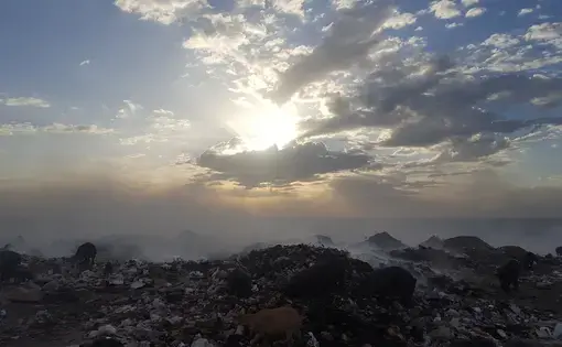 The garbage dump at Truitter, outside Port-au-Prince, burns day and night. After the 2010 earthquake in Haiti, raw sewage was also dumped there until a new site was built. Image by Rebecca Hersher. Haiti, 2017.