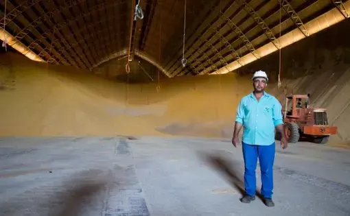 In Sinop, a laborer shows an enormous grain repository, where soy and corn are stored in temperature—and humidity—controlled conditions to gradually be transported by truck and then exported. Image by Heriberto Araújo. Brazil, 2019.