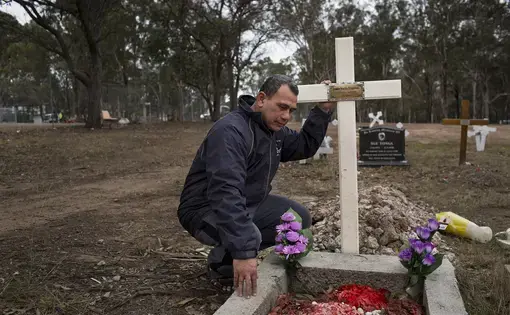 Vaea Togatuki, 48, visits the grave of his son, Junior, who died by suicide on September 11, 2015 while incarcerated in Goulburn’s Correctional Center. Image by David Maurice Smith for The New York Times. Australia, 2018.