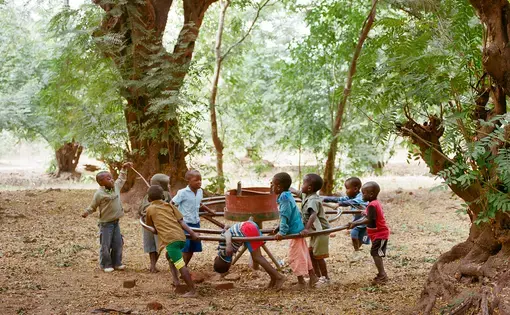 Children play on a broken PlayPump in Mfera, Chikhwawa District, Malawi, June 10, 2015. The PlayPump in Mfera was installed on February 11, 2009, and stopped working in April 2012. The organization that installed it replaced a perfectly working handpump, and the PlayPump never pumped as much water as the handpump. After the PlayPump broke, it was replaced with another handpump. Media file: 005_smaller.jpg
