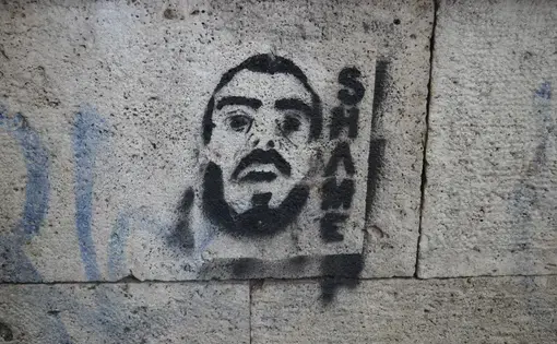 Anti-immigrant graffiti is splashed along the walls of the Tiber River, which runs through the center of Rome. Image by Amanda Ulrich. Italy, 2016.