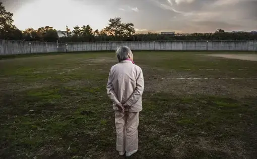 Ms. K, 89, stands in prison yard. Image by Shiho Fukada. Japan, 2018.