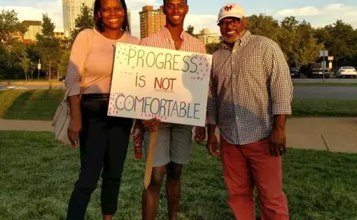 The Washingtons, Theo, Denise and their son, Teddy at a rally supporting racial equity in Clayton, Mo. Courtesy of the Washington family. United States, 2019.