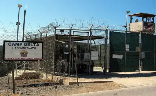 The entrance to Camp 1 in Guantanamo Bay's Camp Delta. The base's detention camps are numbered based on the order in which they were built, not their order of precedence or level of security. Image by Kathleen T. Rhem/Wikimedia Commons. Cuba, 2005.