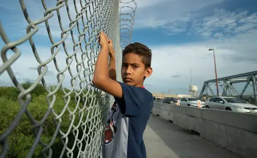 Javier Alejandro Vindel-Rodriguez on the Brownsville Express International Bridge, where U.S. Customs and Border Patrol agents deterred asylum seekers like his family from crossing the border. Image by Reynaldo Leal. United States, 2018.