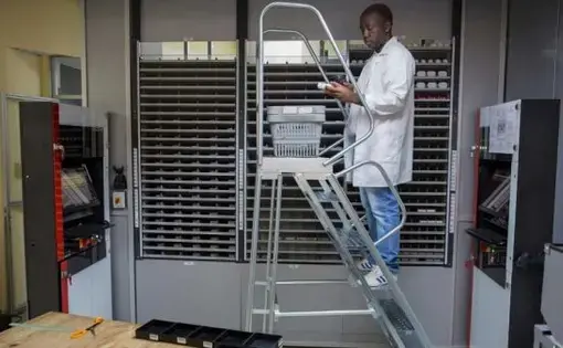 Pharmacy staffer scans pill bottles