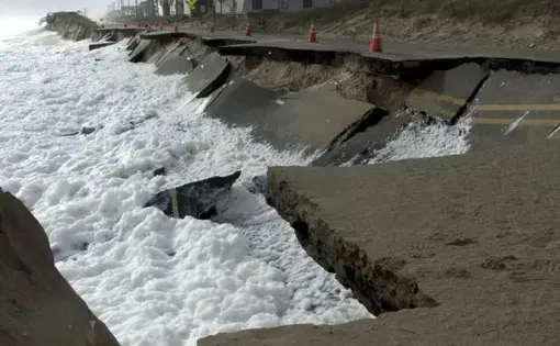 Waves lap at N.C. 12 in Kitty Hawk at low tide Oct. 10, 2016. This section has since been repaired. Image by Kip Tabb. United States, 2016.