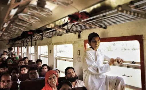 Kashmiri's travel by train near Sopore, a town in the Baramulla district on the Northwestern edge of the Kashmir valley. The 345 km rail line from Baramulla to Jammu, which is still under construction, will eventually connect the disputed territory of Jammu and Kashmir with the rest of India. Image by Sara Hylton. India, 2016. Media file: img_3119.jpg