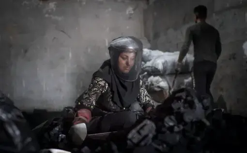 Gorgan, Iran – June, 2020. Maryam, 34, is a daily-paid worker at a charcoal packaging workshop. She, who is a mother of two, has been working there since eight months ago. She described coronavirus pandemic as a total disaster. “My husband, who is a construction worker, was out of work for two months due to coronavirus outbreak and if I along with my co-workers did not plead with our employer, I would be out of work too and would not know how to make a living,” Maryam said. “Poverty and unemployment kill…