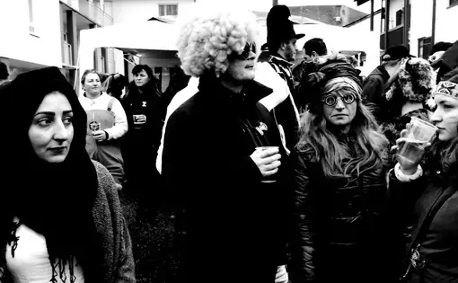 Wesam Daas, left, with Carnival revelers in Altenmarkt, Bavaria. Image by Frank Hessenland. Germany, 2017.