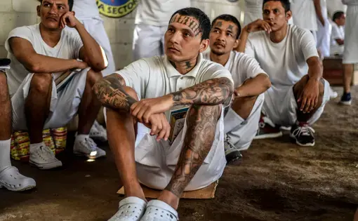 In Apanteos prison, former members of MS-13 who have converted to evangelical Christianity listen to a prison preacher. Image by Danny Gold. El Salvador, 2019.
