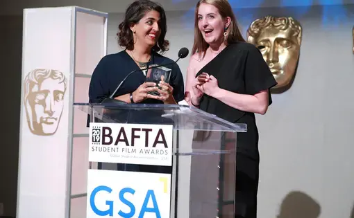 Ingrid Holmquist and Sana Malik, student fellow alumni, receive a BAFTA award. Image by BAFTA Los Angeles. United States, 2019.