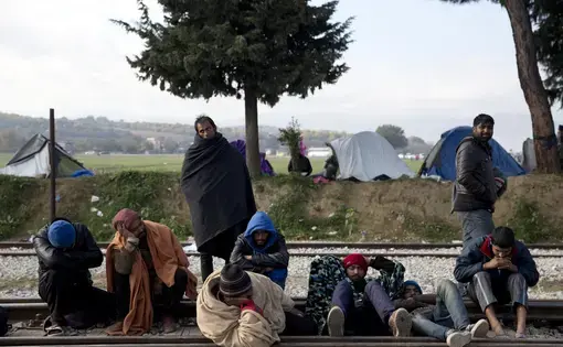 immigrants sleeping on tracks