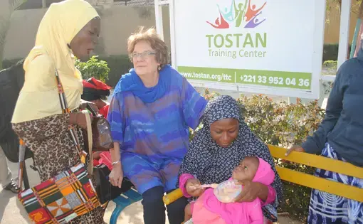 Molly Melching, founder of Tostan, a nonprofit based in Senegal, with participants from a workshop for religious and community leaders from Ghana and Nigeria. Image by Amy Yee. Senegal, 2017.