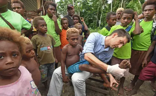 Oriol Mitjà, whose work has triggered a new yaws eradication effort, examines a young patient named Jeremiah, who has an active infection, but can be cured with a dose of azithromycin. Image by&nbsp;Brian Cassey.&nbsp;Papua New Guinea, 2018.&nbsp;