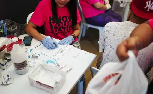 Health officials conduct rapid HIV testing during a fun run in Cebu City. Image by Veejay Villafranca. Philippines, 2015.
