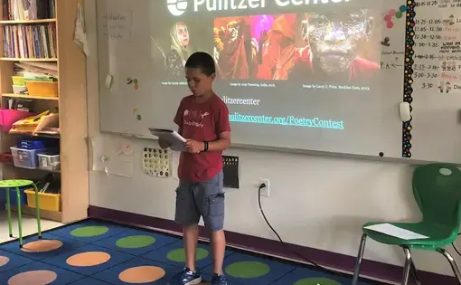 A 3rd grade student at Washington Yu Ying Public Charter School in D.C. performs their Fighting Words poem for the class. Image by Hannah Berk. United States, 2019.