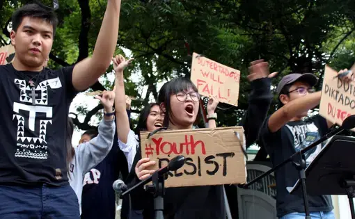 Shibby de Guzman, 13, center, joins other youths Tuesday at a Manila rally to protest policies of the Duterte government. Image by Ana P. Santos. Philippines, 2017.