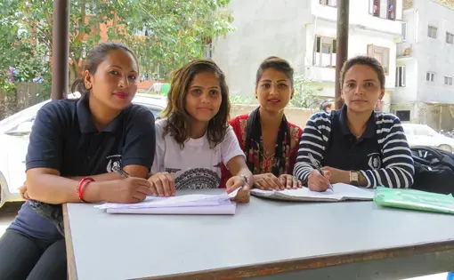 Survivors and certified paralegals Renuka, Bidhya, Apsara, and Santa work in a Kathmandu police station filing criminal complaints. Image by Nicole Brigstock. Nepal, 2018. 