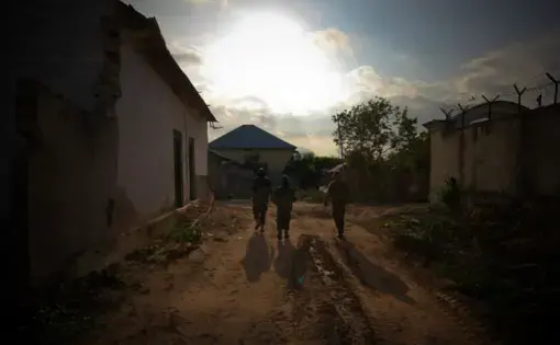 Ugandan soldiers serving with the African Union Mission in Somalia (AMISOM) 33rd Battalion walk between defensive positions along the frontline in Yaaqshiid District of Mogadishu, where AMISOM forces have pushed Al Shabaab militants beyond the city's northern fringes to the outskirts of the Somali capital. AU/UN Image by Stuart Price. Somalia, 2011. (CC0 1.0).