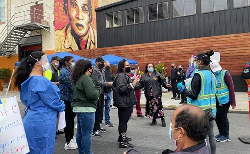 The Latino Task Force leaders—Jon Jacobo in the cap, Susana Rojas and Tulier-Laiwa in the front—briefing volunteers and workers on testing protocol at the Thursday mobile site. Image by Lydia Chávez. United States, 2020.