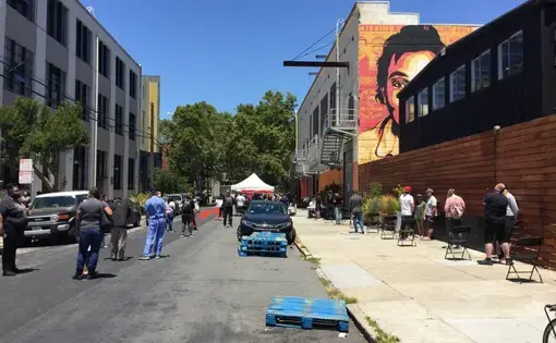 People waiting in line at the Mission COVID-19 mobile testing site at 701 Alabama Street on July 9, 2020. Image by Michael Toren. United States, 2020.