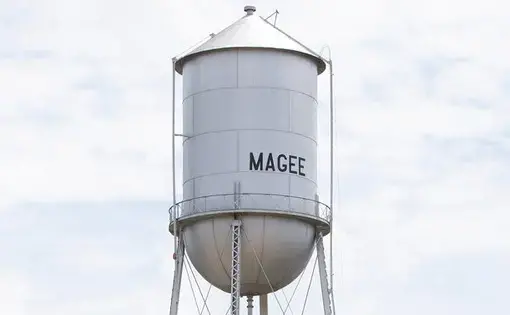 The Magee, MS water tower stands not far from the parking lot at the main entrance to Magee General Hospital in Magee. The hospital was incorporated in 1942 and primarily serves Simpson County's rural population. Image by Sarah Warnock/MCIR. United States, undated.