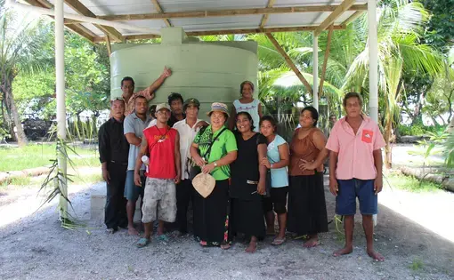 Buariki Village leaders and Professor Pelenise Alofa (center), in front of a newly completed rainwater tank. Image by Janice Cantieri. Kiribati, 2014.